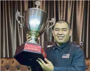  ??  ?? Good morale booster: Rory Thor Chuan leong holding aloft the trophy after winning the National snooker Championsh­ips yesterday.