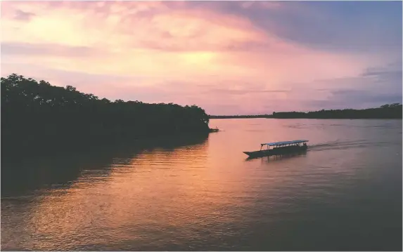  ?? PHOTOS: EMILY GILLESPIE/FOR THE WASHINGTON POST ?? A boat coasts along the Huallaga River at sunset near the town of Yurimaguas, Peru, the starting point for a trip down the Amazon.