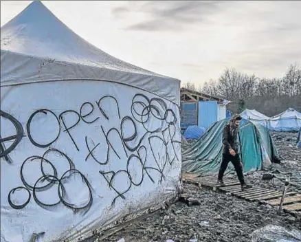  ?? YVES HERMAN / REUTERS ?? “Abran la frontera”, reza un mensaje en una tienda de migrantes cerca de Dunkerque (Francia)