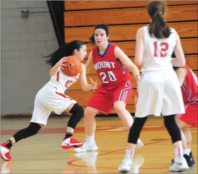  ?? Photos by Ernest A. Brown ?? Mount St. Charles forward Haley Leclerc (24) attempts to keep an East Providence guard out of the paint during the second half of the No. 4 Townies victory over Lena Nguyen (below) and the Mounties in a Division II preliminar­y round game Saturday...