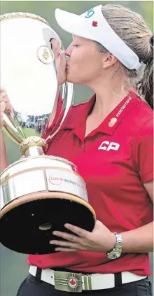  ?? CANADIAN PRESS FILE PHOTO ?? Canadian golfer Brooke Henderson kisses the trophy after winning the CP Women’s Open in Regina on Aug. 26.