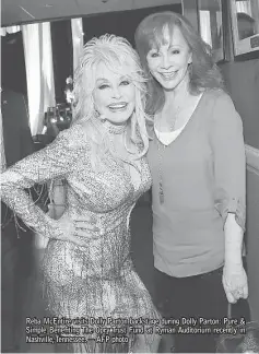  ?? — AFP photo ?? Reba McEntire visits Dolly Parton backstage during Dolly Parton: Pure & Simple Beneiting The Opry Trust Fund at Ryman Auditorium recently in Nashville, Tennessee.