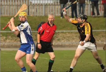  ??  ?? Referee Kevin Kehoe has the best view in the house as James Redmond strikes past James Delaney.