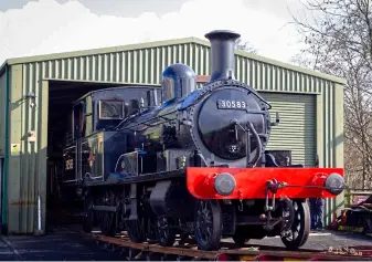  ?? BOTH: JAMES CUMMINS ?? LEFT Ex-Lyme Regis branch Adams ‘Radial’ No. 30583 is carefully moved into Atlantic House on March 6, ahead of its planned overhaul.