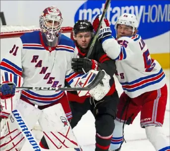  ?? Sean Kilpatrick/Canadian Press ?? Ottawa’s Vladimir Tarasenko finds himself sandwiched between Rangers goaltender Igor Shesterkin, left, and New York Rangers defenseman Ryan Lindgren Tuesday night in Ottawa.