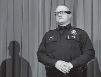  ?? Photos by Kathryn Scott Osler, The Denver Post ?? Denver police Detective JohnMedfor­d wears a body camera during a news conference at police headquarte­rs Friday. The first batch of cameras hits the streets Thursday night after 80 officers were trained to use them.