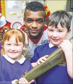  ?? Picture: Andy Payton FM4670718 ?? Courtney Tulloch with Shelby, 4, and Arthur, 5, right, with Courtney’s Olympic torch at Archbishop Courtenay Primary in Tovil
