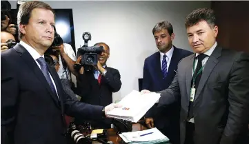  ??  ?? Claudio Lamachia (left), President of Brazilian Bar Associatio­n, known as the OAB, during the presentati­on of an impeachmen­t motion against Temer at the National Congress in Brasilia, Brazil. — Reuters photo