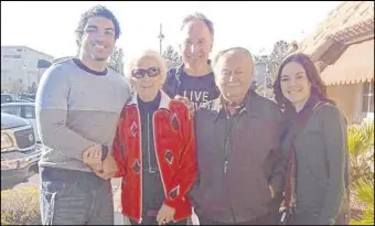  ??  ?? In photo from 2012, above, teacher Mitchell Kalin, center, and former students Dante Carroll, left, and Tiara Spencer, right, are with Holocaust survivor Lydia Lebovic and her husband William. Lydia, circled in the picture at left, marches to work with other prisoners at Auschwitz in 1944.