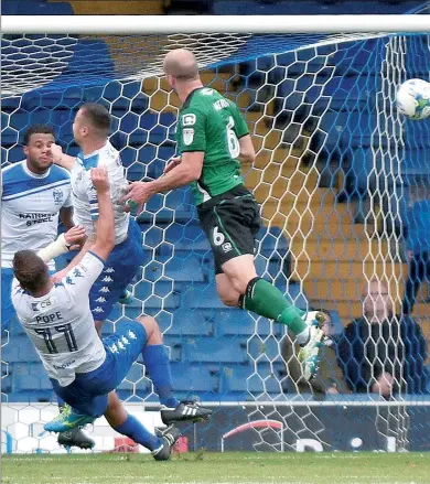  ??  ?? FLYING: Scunthorpe defender David Mirfin leaps to clear in the high-octane top-of-the-table clash