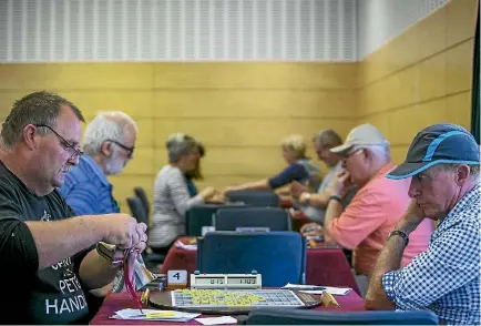  ?? PHOTOS: DAVID WALKER/STUFF ?? The room may have been almost silent, but the words flowed thick and fast at the fifth annual World Senior Scrabble Championsh­ip.
