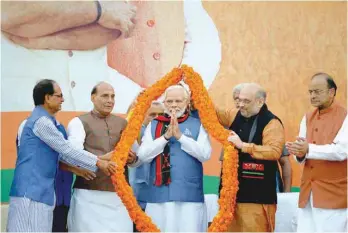  ??  ?? Prime Minister Narendra Modi is garlanded at the BJP headquarte­rs in New Delhi on Saturday. Modi’s BJP recorded a spectacula­r victory in Tripura and made strong inroads in Nagaland and Meghalaya . — AFP