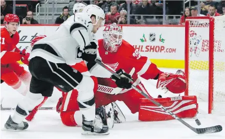  ??  ?? Detroit Red Wings goaltender Jimmy Howard stretches to stop a shot by Los Angeles Kings winger Austin Wagner during the first period in Detroit on Monday. Howard made 42 saves and Dylan Larkin scored his 12th goal of the season to lead the Wings to a 3-1 victory. The Kings are now tied with the Chicago Blackhawks for fewest points in the NHL.