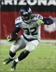  ?? RICK SCUTERI — THE ASSOCIATED PRESS ?? Christine Michael runs for Seattle against the Cardinals in Glendale, Ariz. The recently acquired back looks like he’ll finally get a chance to take a few carries on Monday night when the Packers visit the Eagles.