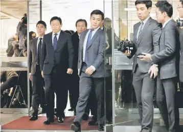  ??  ?? Lotte Group chairman Shin Dong-bin (second left) arrives for a trial at a court in Seoul, South Korea. Four members of the family who control South Korea’s troubled retail giant Lotte, including its 93-year-old founder, went on trial yesterday for...