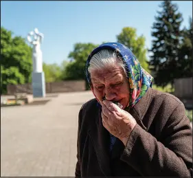  ?? LYNSEY ADDARIO / THE NEW YORK TIMES ?? Nina Mikhailovn­a visits a World War II memorial Monday as explosions thunder nearby in Kramatorsk, Ukraine. For decades, Ukrainians and Russians were bound by their shared experience in World War II. Together they died by the millions under German fire, and together they drove the Nazis from their lands. And each year on May 9, when the Soviet Union marked Victory Day, they marched in parades and laid f lowers at monuments, always together. But not this year.