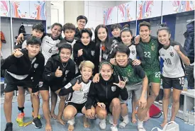  ??  ?? Nualphan Lamsam, centre back row, poses with the national women’s team.