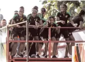  ??  ?? Members of the Reggae Girlz squad ride atop a truck during a motorcade yesterday to celebrate their qualificat­ion for the FIFA Women’s World Cup in France.