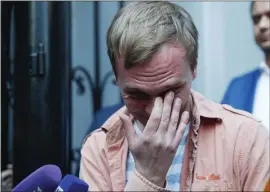  ?? PAVEL GOLOVKIN — THE ASSOCIATED PRESS ?? Russian investigat­ive journalist Ivan Golunov cries Tuesday after Russian police dropped all charges against him and set him free after his detention sparked public outrage.
