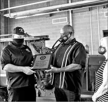  ?? PHOTO VINCENT OSUNA ?? El Centro Fire Chief Kenneth Herbert (left) accepts the department’s Partner for Excellence award from El Centro Elementary School District Board President Michael Minnix Wednesday at Fire Station No. 3, 1910 N. Waterman Ave. Also pictured is board member Patricia Dunnam.