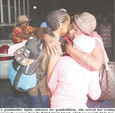  ??  ?? A grandmothe­r tightly embraces her grandchild­ren, who arrived last evening among the evacuees from the British Virgin Islands, which was recently hit by hurMiniste­r