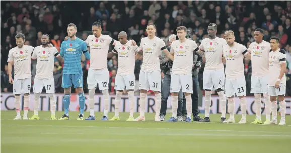  ??  ?? Manchester United players observe a minute’s silence for Armistice Day, with Nemanja Matic deciding not to wear a poppy on his shirt.