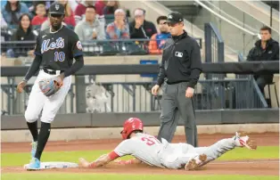  ?? MARY ALTAFFER/AP ?? Fill-in Phillie Weston Wilson, right, steals third past New York Mets third baseman Ronny Mauricio in the ninth inning of game 1 of a doublehead­er in New York on Saturday night.