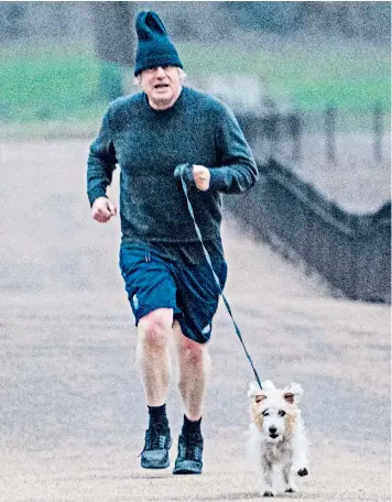  ??  ?? On the eve of the Budget, Boris Johnson goes for a jog in the park with Dilyn, the Downing Street dog