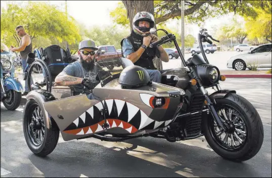  ?? Chase Stevens Las Vegas Review-Journal @csstevensp­hoto ?? U.S. Army veterans Jose “Freddy” Ruiz, left, of San Antonio, and Richard Neider, of Phoenix, prepare for the start of the Veterans Charity Ride to the Sturgis Motorcycle Rally in South Dakota outside of the Nevada Veterans Memorial in Las Vegas.