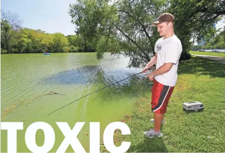  ?? MIKE DE SISTI / MILWAUKEE JOURNAL SENTINEL ?? Michael Bonin of Milwaukee tries his luck fishing at Juneau Park Lagoon on Wednesday. A toxic algae bloom at the lakefront lagoon has forced the cancellati­on of an internatio­nal water ski competitio­n. To view a photo gallery and video, go to...