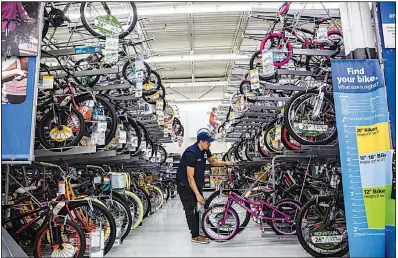  ?? Bloomberg News file photo ?? An employee arranges bicycles at a Walmart store in Secaucus, N.J. Walmart says its newly patented Listening to the Frontend device is a “concept” that would help gather metrics to improve the checkout process.