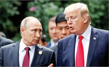  ?? REUTERS ?? Russian President Vladimir Putin and US President Donald Trump talk during the family photo session at the APEC Summit in Danang, Vietnam on Saturday.