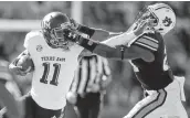  ?? Todd Kirkland / Associated Press ?? Auburn’s Daniel Thomas grabs the face mask of Texas A&amp;M’s Kellen Mond during the second half.