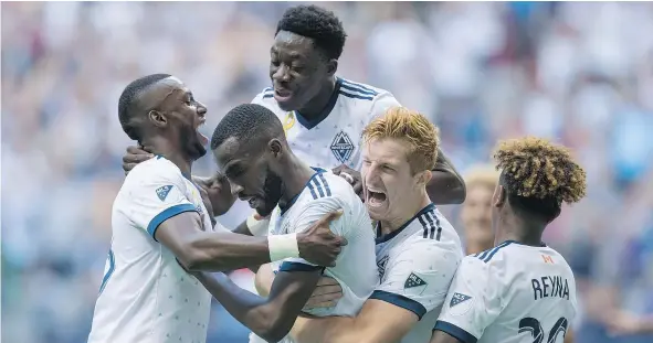  ?? — PHOTOS: THE CANADIAN PRESS ?? From left, Whitecaps Bernie Ibini, Tony Tchani, Alphonso Davies, Tim Parker and Yordy Reyna celebrate Tchani’s tying goal against the Columbus Crew on Saturday. “When I scored, I didn’t realize I was playing against my former team,” said Tchani.