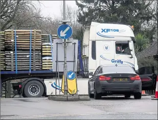  ??  ?? A lorry attempts to turn into Mersham on Monday as drivers continue to struggle to find the Sevington lorry park