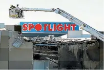  ?? PHOTO: GETTY IMAGES ?? Investigat­ors use a crane to view the damage caused when a charter plane crashed into the DFO Melbourne Shopping Centre, killing the pilot and four American passengers.