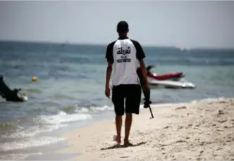  ?? FOTO REUTERS ?? Een gewapende agent op het strand van Sousse, waar in 2015 een bloedige terreuraan­slag 38 dodelijke slachtoffe­rs maakte.