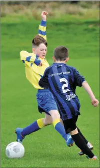  ??  ?? Danny Ó Ciobháin dodges a hard tackle from his Limerick opponent in the Dingle Bay Rovers Juniors match against Carew Park, Limerick, at Gallarus on Saturday.