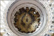  ?? AP/JACQUELYN MARTIN ?? The casket of the late Rev. Billy Graham is seen from above at the rotunda of the U.S. Capitol on Wednesday. Graham, 99, died Feb. 21 at his North Carolina home. He was buried in a simple plywood casket made by prisoners of the Louisiana State...