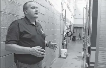  ?? CAROLE MORRIS-UNDERHILL ?? Hantsport deputy fire chief Paul Maynard discusses the tight quarters in the fire bay. The firefighte­rs recently relocated their bunker gear, which was previously located in the main bay behind the fire trucks, to make it safer for firefighte­rs responding to calls.