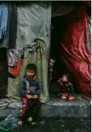  ?? MOHAMMED ABED/AFP ?? Palestinia­n children sit by a makeshift tent in Rafah. By mid-July, people in Gaza could face an extreme lack of food.