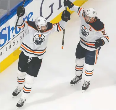  ?? CODIE MCLACHLAN / THE CANADIAN PRESS ?? Leon Draisaitl, left and Connor McDavid are off to great starts, but once again are responsibl­e for most of the Oilers' offence. Draisaitl and McDavid are on pace for a combined 218 points, and that's in a 56-game season.