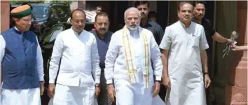  ?? — AFP ?? Prime Minister Narendra Modi walks with senior Bharatiya Janata Party (BJP) leaders after arriving for the monsoon session of Parliament in New Delhi on Wednesday.