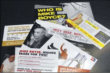  ?? KENT D. JOHNSON / KDJOHNSON@AJC.COM ?? Direct mail pieces disparagin­g retired Col. Mike Boyce were part of the failed campaign to re-elect Cobb County Commission Chairman Tim Lee. Lee and the groups supporting him outspent Boyce and his allies 4 to 1. Lee benefited from secret, dark money spent by the Revitalize America Fund, a social welfare organizati­on that ponied up $150,000 for the chairman between May and July.