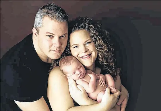  ?? CONTRIBUTE­D ?? Stephen and Stephanie Ryan cuddle their son, Dominic. The Conception Bay South couple faced a tough journey to parenthood as they worked together to overcome male infertilit­y. Their dream recently came true with their baby’s safe arrival.