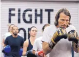  ?? GLENN KOENIG/LOS ANGELES TIMES ?? Steve O’Brien, right, and other class members are ready to start their workout at the boxing fitness class at Prevail Boxing in Los Angeles.