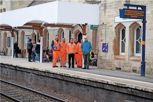  ?? PAUL STEPHEN. ?? Graham Taylorson (centre), senior asset engineer at Network Rail LNE and East Midlands, and Andy Savage (right), executive director of the Railway Heritage Trust, stand beneath the new canopy with contractor­s involved in the upgrade project.