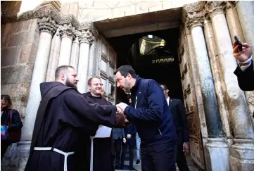  ??  ?? Salvini shakes hands with Franciscan friars at the end of a visit to the Church of the Holy Sepulchre in the Old City of Jerusalem. — AFP photo