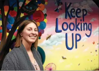  ?? CARL HESSLER JR. — DIGITAL FIRST MEDIA ?? Skippack artist Chelsea Allen smiles as she unveils the mural “Keep Looking Up” that she designed for Montgomery County Court Care facility Thursday.