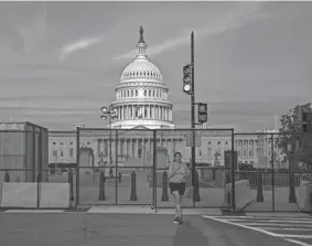  ?? J. SCOTT APPLEWHITE/AP ?? With police preparing for the possibilit­y that some demonstrat­ors might arrive with weapons in Washington on Saturday, fencing around the Capitol is back up.